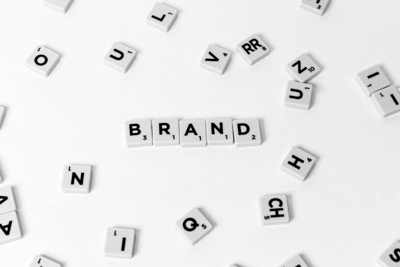 the word "brand" written on small white tiles